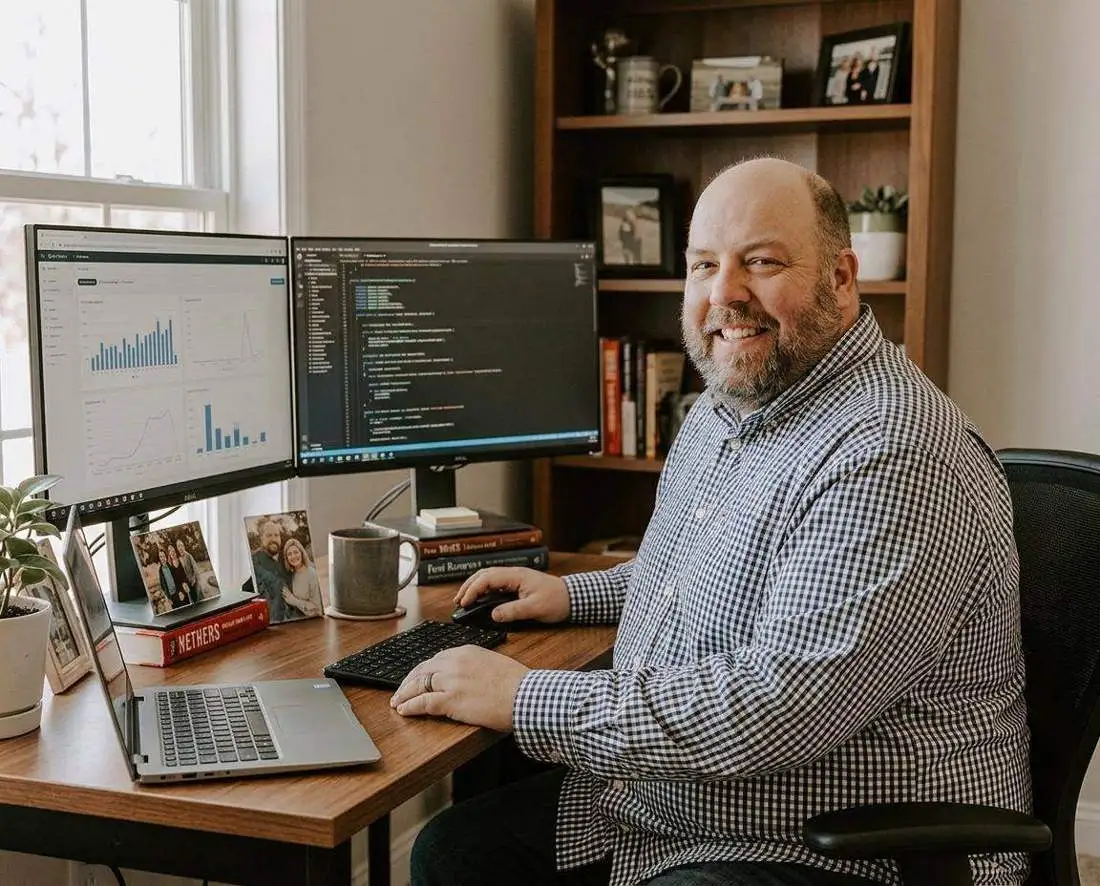 Andy Culver working at his desk in his home office in the St Croix River Valley